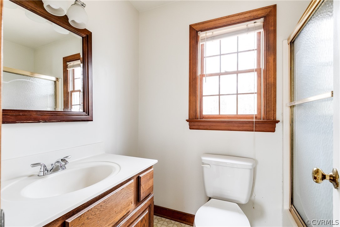 11036 Rufford Road Chester, VA 23831 - Photo 19 of 35 a bathroom with a toilet sink and mirror