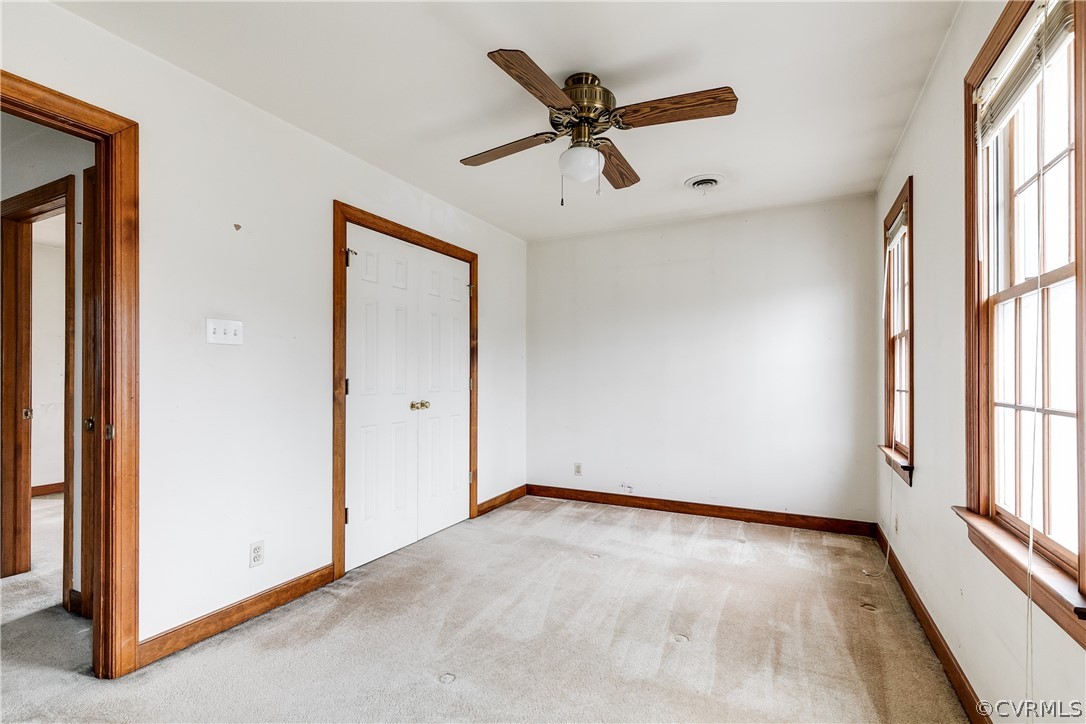 11036 Rufford Road Chester, VA 23831 - Photo 27 of 35 an empty room with a window and a ceiling fan