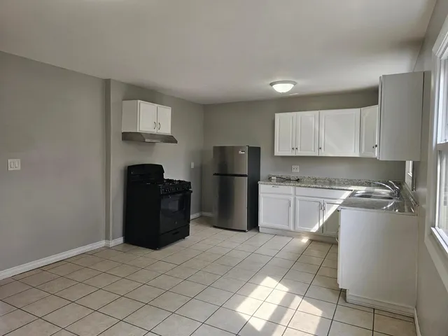 a kitchen with stainless steel appliances granite countertop a refrigerator sink and cabinets