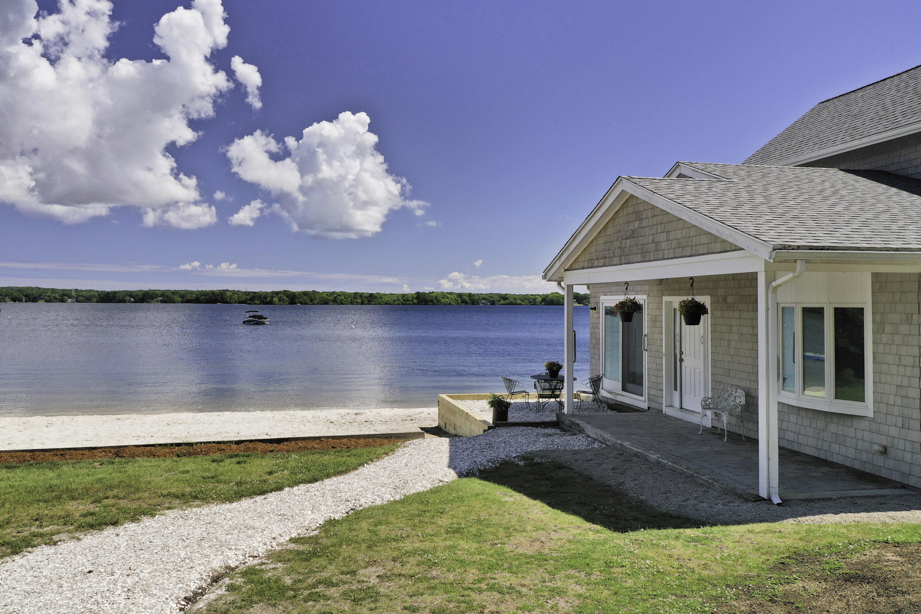 a view of a house with yard and lake view