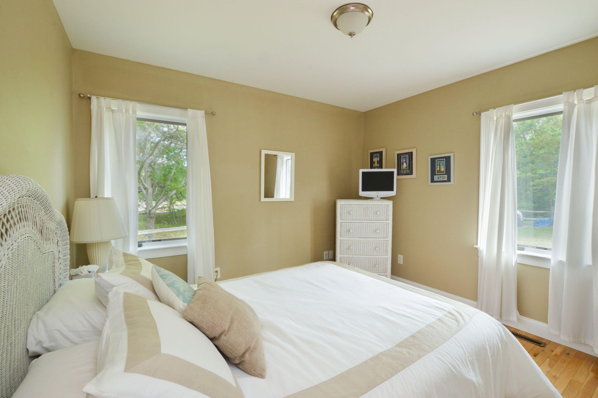 97 Willow Run Drive Centerville, MA 02632 - Photo 18 of 30 a bedroom with a bed and wooden floor