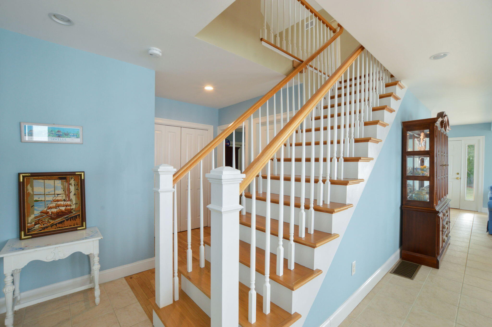 97 Willow Run Drive Centerville, MA 02632 - Photo 20 of 30 a view of staircase with lots of frames on wall and a window