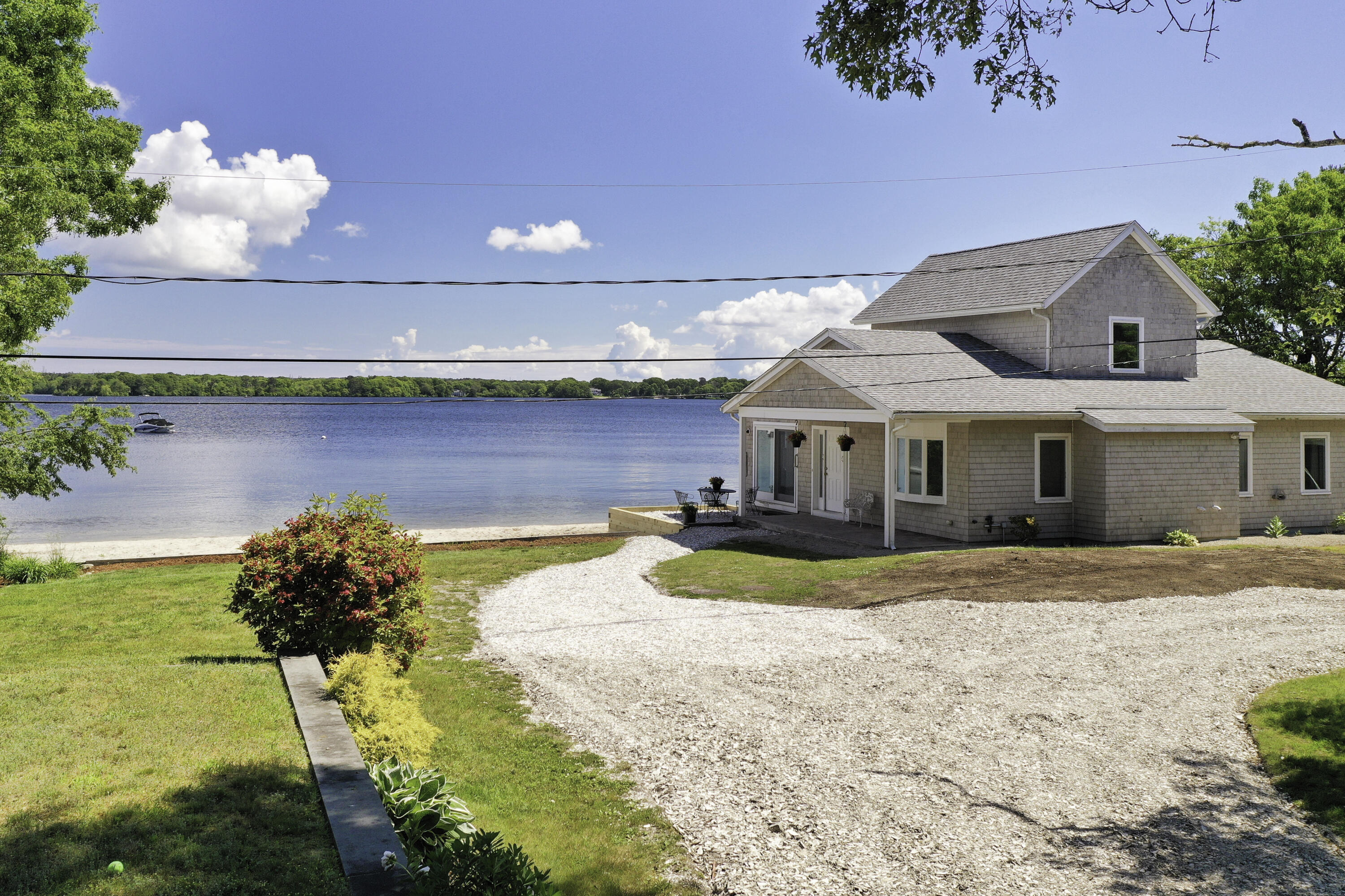 97 Willow Run Drive Centerville, MA 02632 - Photo 2 of 30 a front view of a house with swimming pool