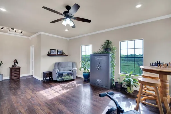 a living room with furniture and wooden floor