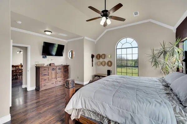 a bedroom with a bed window and a flat screen tv