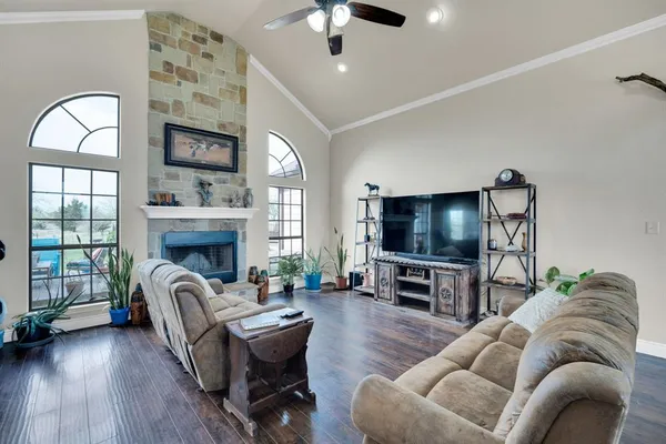 a living room with furniture a flat screen tv and a fireplace