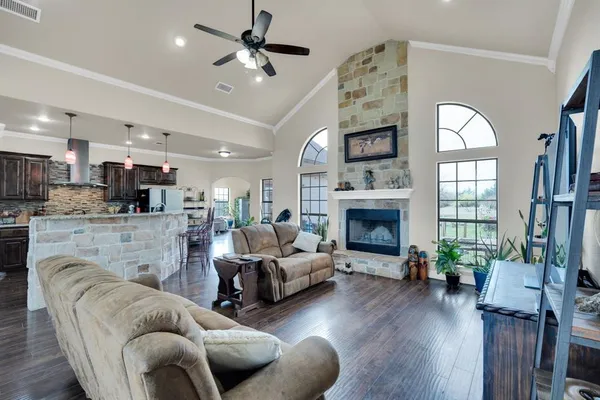 a living room with furniture a fireplace and wooden floor