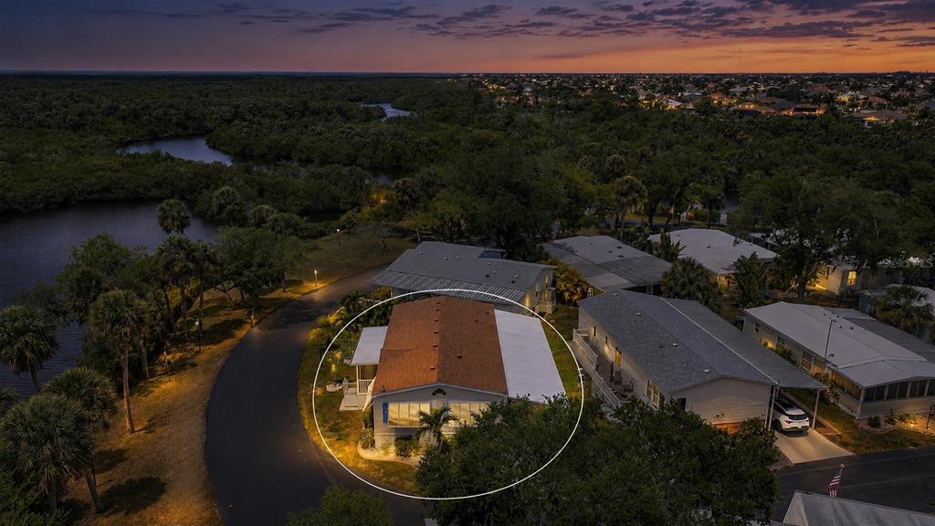 10303 Burnt Store Road, Unit 143 Punta Gorda, FL 33950 - Photo 1 of 42 an aerial view of swimming pool and lake view