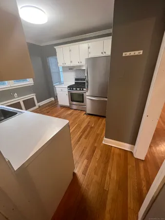 a kitchen with stainless steel appliances a refrigerator and a stove