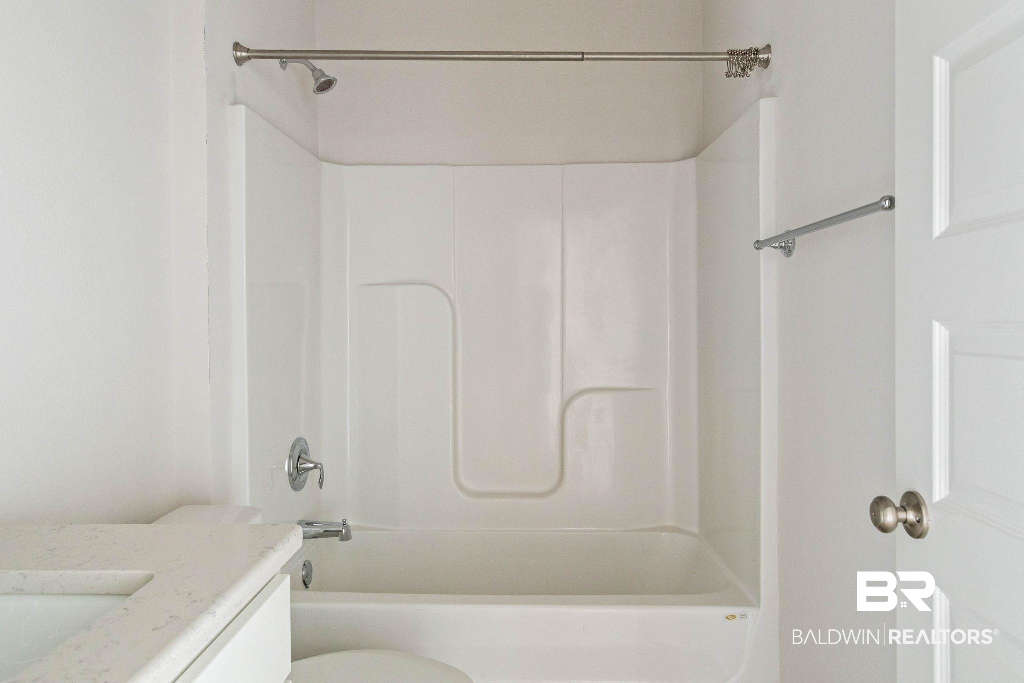 1710 Grouse Street Foley, AL 36535 - Photo 57 of 76 Built-in bathtub with integrated shower, chrome fixtures, and a curved shower rod