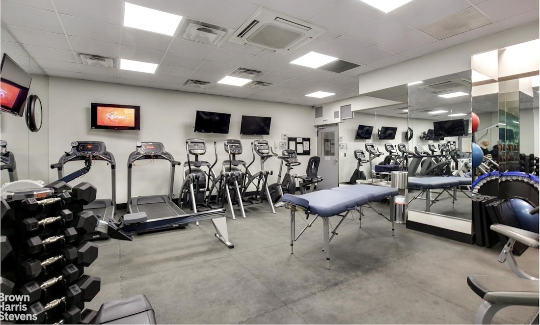150 East 61st Street, Unit 5F Manhattan, NY 10065 - Photo 12 of 15 a view of a room with gym equipment