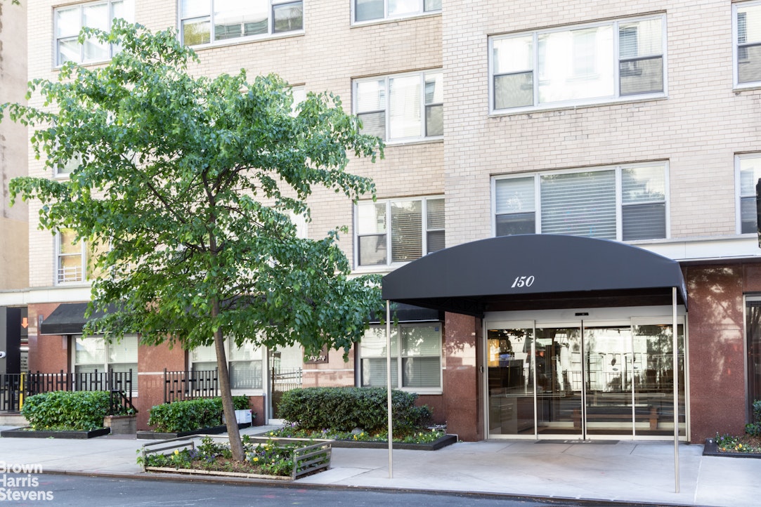 150 East 61st Street, Unit 5F Manhattan, NY 10065 - Photo 14 of 15 a view of a brick house with a plants and large trees