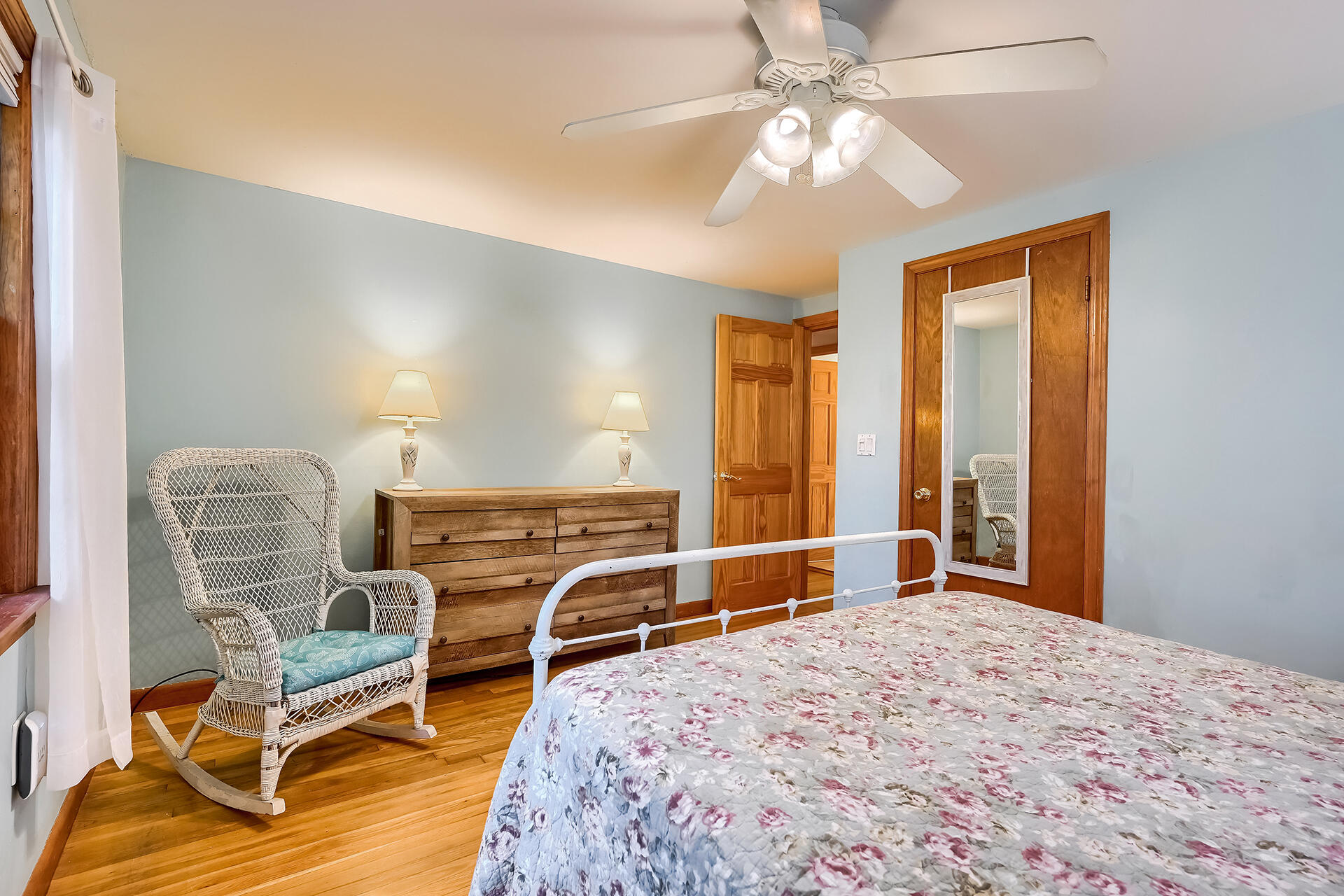 11 Mizzentop Lane Centerville, MA 02632 - Photo 10 of 18 a bedroom with a bed a chandelier and dresser