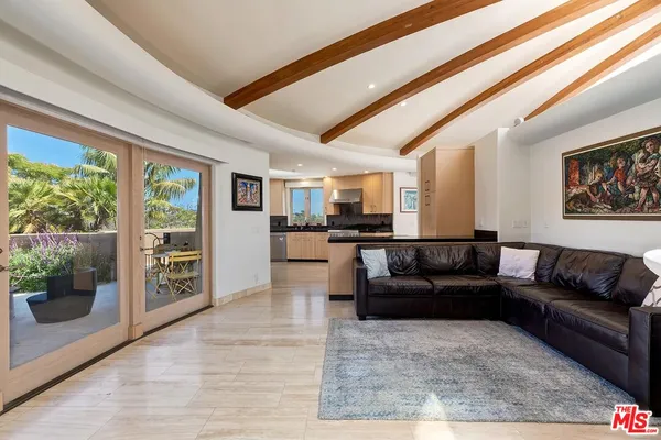 a living room with furniture and a floor to ceiling window