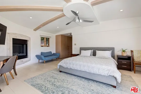 a bedroom with bed and a chandelier