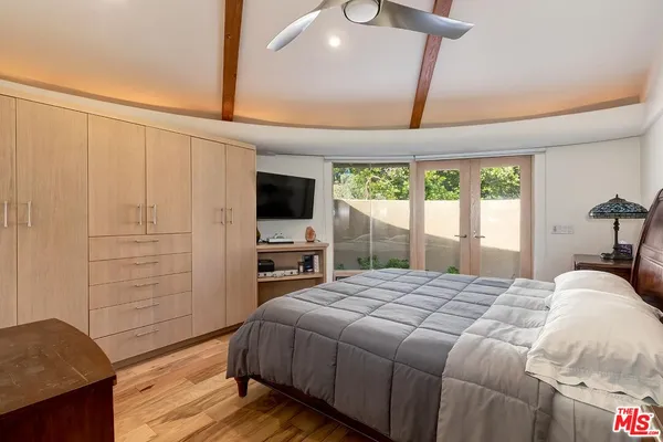 a bedroom with a bed and a flat tv screen