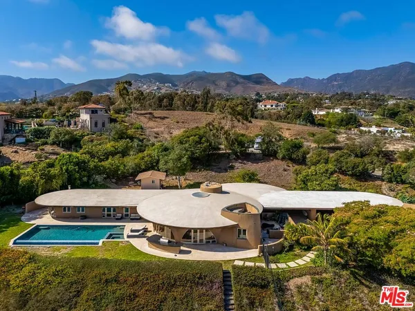 an aerial view of a house with a swimming pool mountain view and mountain view