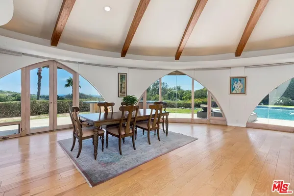 a view of a dining room with furniture window and wooden floor