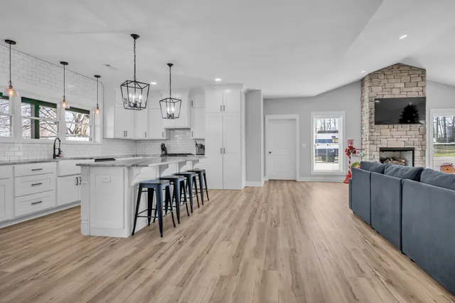 a kitchen with stainless steel appliances granite countertop a kitchen island a stove and a cabinets