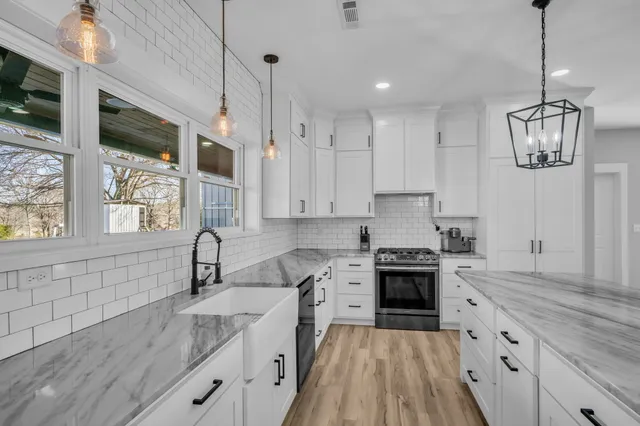 a view of hallway with window and cabinet