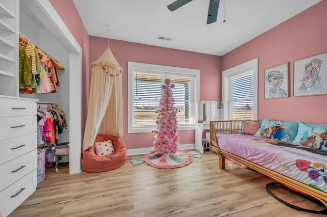 a large bedroom with a bed and a large window