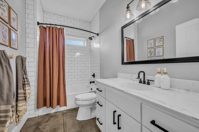 a living room with furniture a ceiling fan and a rug