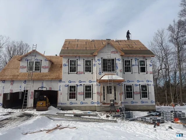 a front view of a house with yard and seating space