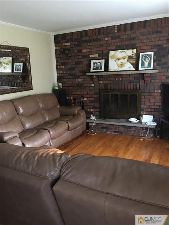 17 Stockton Road New Brunswick, NJ 08901 - Photo 3 of 12 a living room with furniture and a fireplace