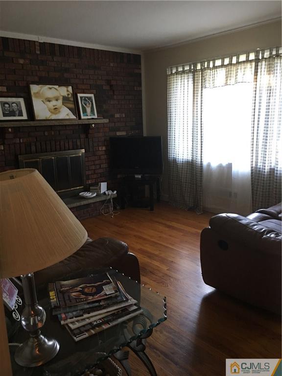 17 Stockton Road New Brunswick, NJ 08901 - Photo 6 of 12 a room with furniture and a fireplace