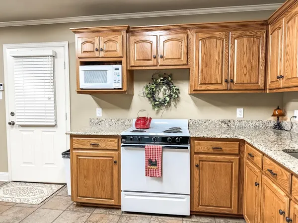 a kitchen with stainless steel appliances granite countertop a refrigerator sink and stove