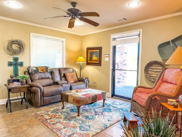 a living room with furniture a couch and a window