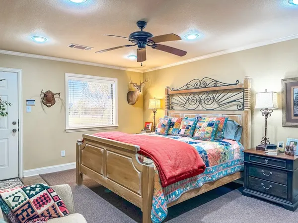 a bedroom with a bed couch and a window