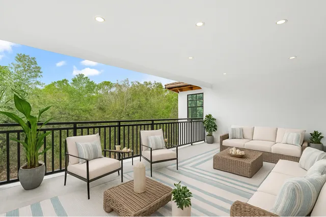 a balcony with furniture and a potted plant
