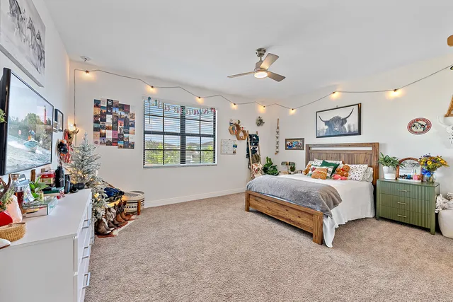 a bed room with furniture and a flat screen tv