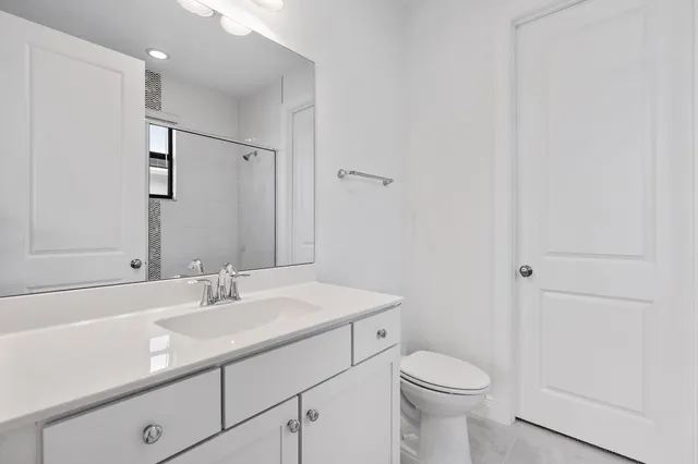 a bathroom with a sink toilet and a mirror