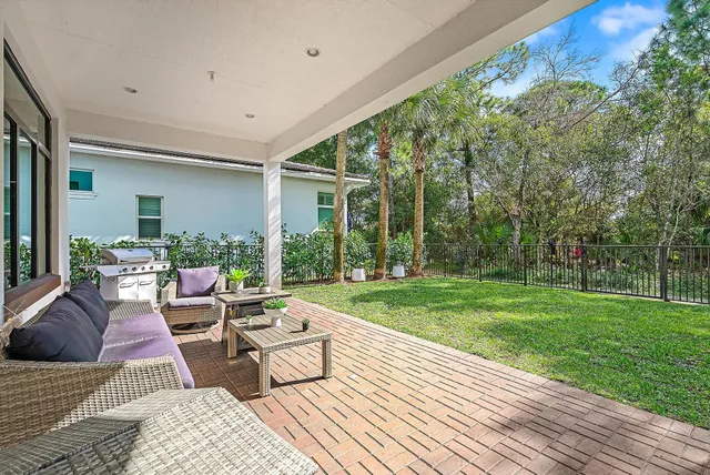 a living room with patio furniture and garden