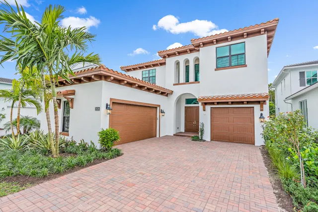 a view of a house with a yard and a garage