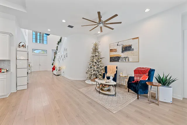 a living room with furniture and a potted plant