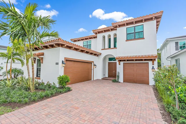 a view of a house with a yard and a garage