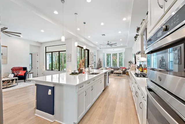 a large white kitchen with a large window