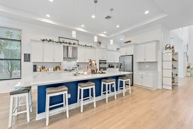 a kitchen with stainless steel appliances a sink and a refrigerator