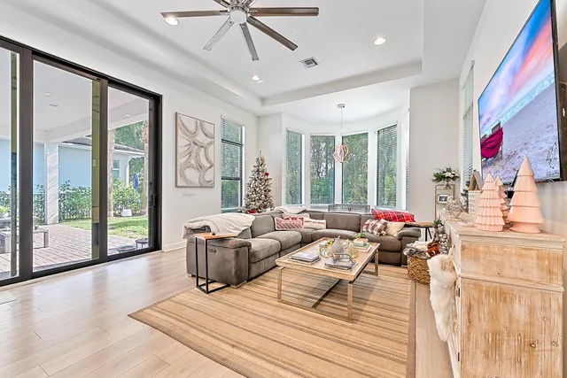 a living room with furniture and large windows