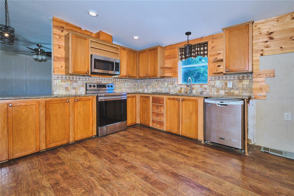 2701 Murphy Road Ona, FL 33865 - Photo 15 of 41 a kitchen with stainless steel appliances granite countertop a stove top oven a sink and dishwasher