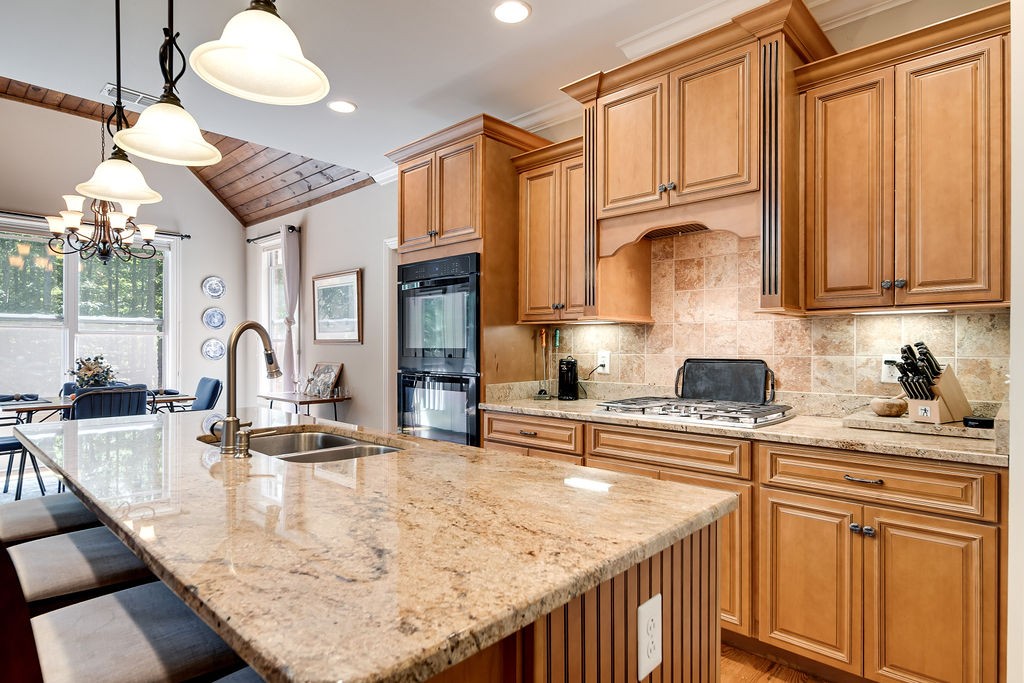 5751 Pinewood Road Franklin, TN 37064 - Photo 14 of 50 a kitchen with stainless steel appliances granite countertop a sink a stove and a wooden cabinets