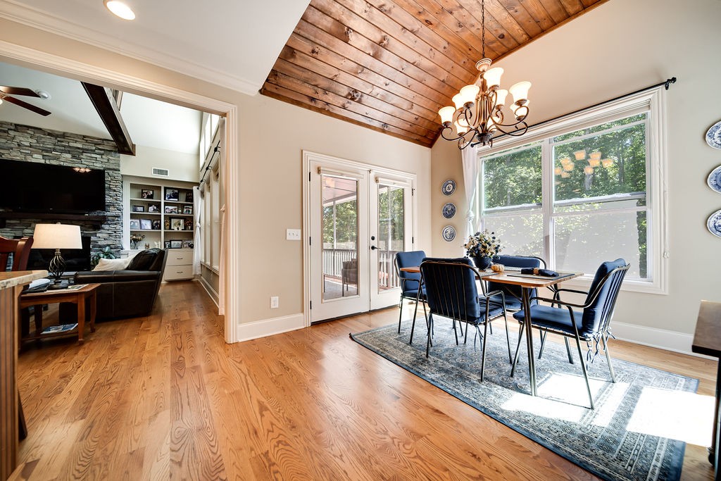 5751 Pinewood Road Franklin, TN 37064 - Photo 15 of 50 a view of a dining room with furniture a chandelier and wooden floor