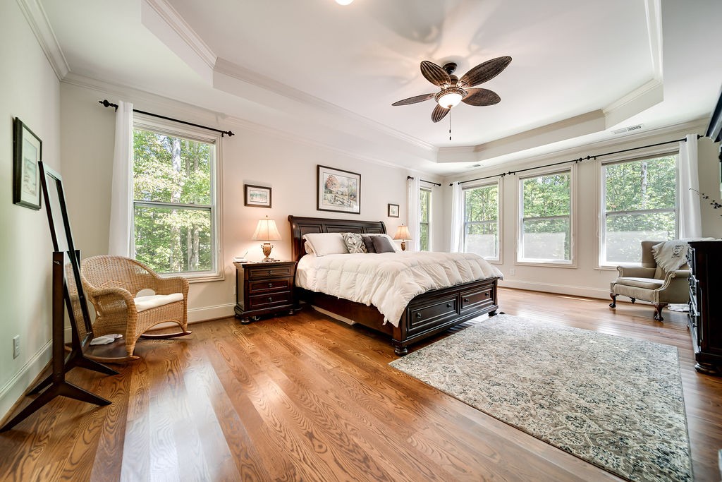 5751 Pinewood Road Franklin, TN 37064 - Photo 17 of 50 a bedroom with a bed a couch and a large window with wooden floor