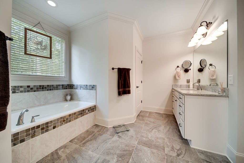 5751 Pinewood Road Franklin, TN 37064 - Photo 24 of 50 a spacious bathroom with a tub sink and mirror