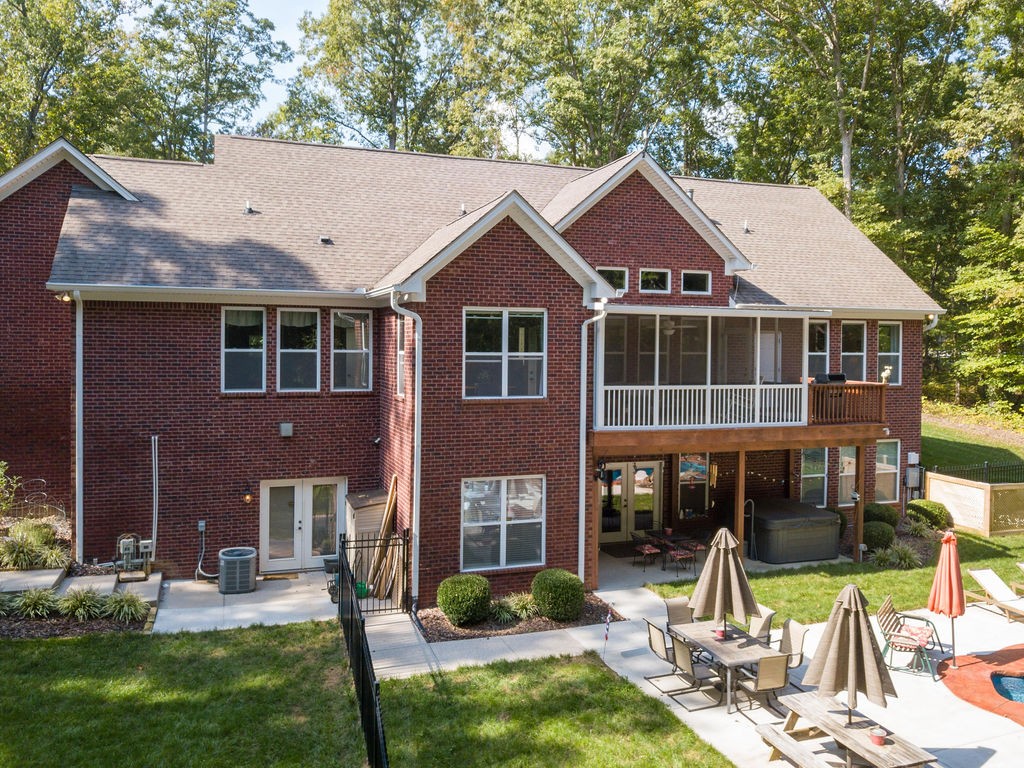 5751 Pinewood Road Franklin, TN 37064 - Photo 48 of 50 a front view of a house with a yard table and chairs