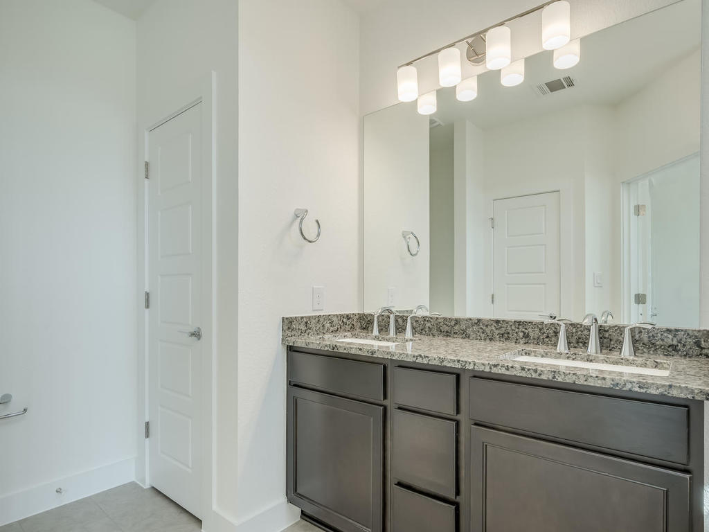 12327 Maypole Bend Austin, TX 78717 - Photo 22 of 30 a bathroom with a granite countertop sink and a mirror