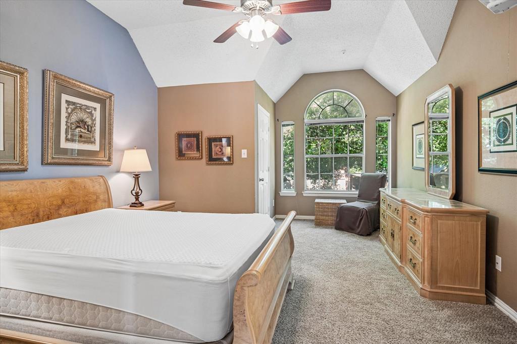 14592 Greenleaf Court Addison, TX 75001 - Photo 14 of 34 Bedroom featuring lofted ceiling, light carpet, and ceiling fan